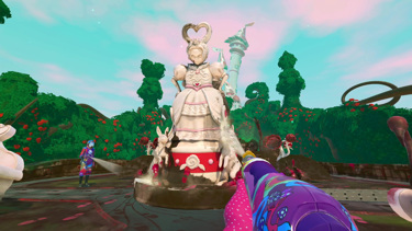 A large statue of the Queen of Hearts looking angrily towards the player as they power wash it. Another player is cleaning the base of the statue. Rose bushes and a fairytale castle can be seen in the background. 